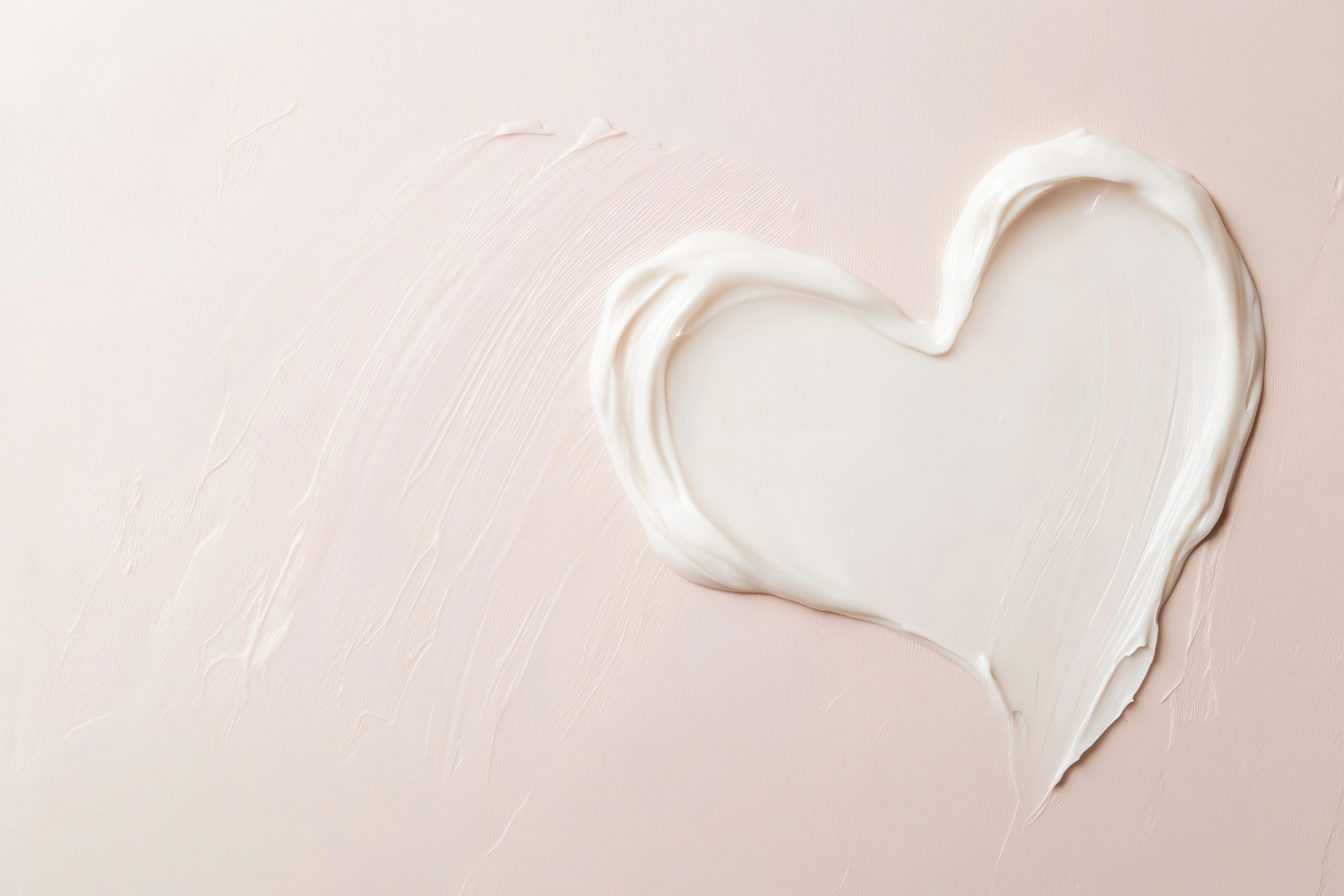 Heart-shaped white smear on a light pink background