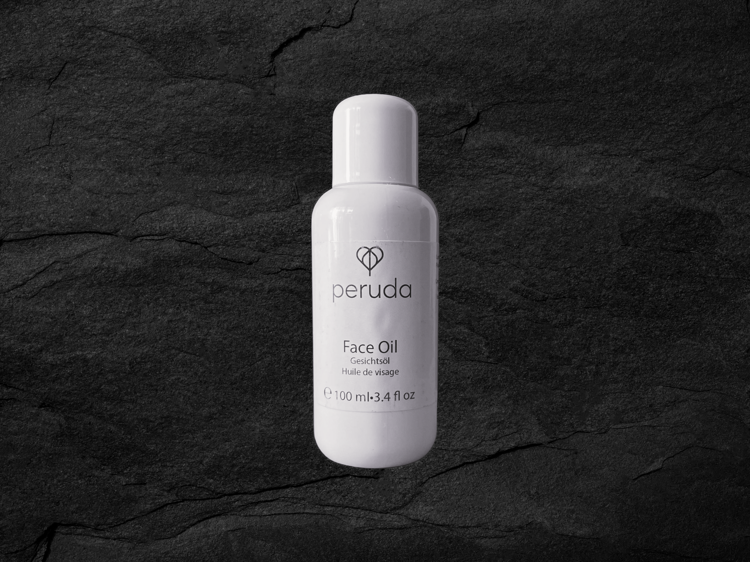 A white 100ml bottle of Peruda Face Oil.