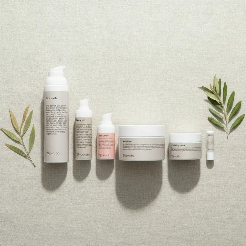 Six skincare products from the brand Typhosa are arranged in a row on a textured light beige fabric background, flanked by decorative olive branches. The products include a hair wash, neck oil, face wash, body wash, body butter, and a small tube, all in neutral white and pale pink packaging with black text.