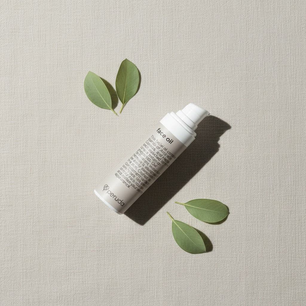 peruda skincare face oil bottle with botanical leaves on a textured beige background