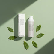 peruda skincare neem face wash bottle and box on a sage green background surrounded by bay leaves